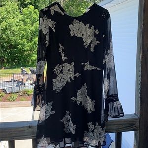 A black dress with white floral print.